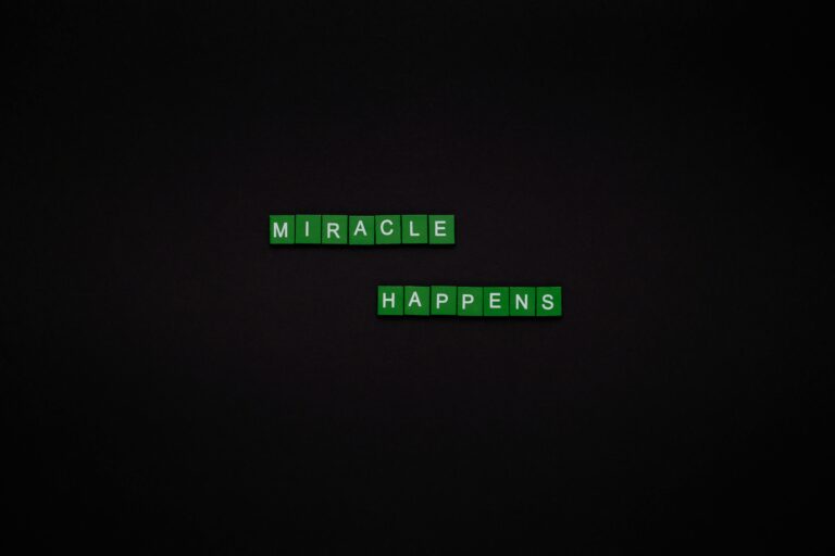 Motivational image featuring the words 'Miracle Happens' using green tiles on a black backdrop.